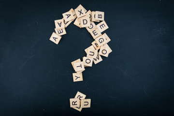 Letters on a black background form a question mark