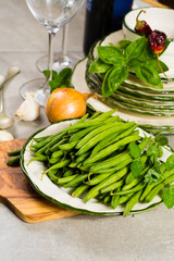 Fresh green snap beans on the plate ready to cook