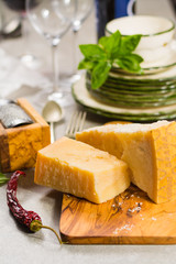 Aged parmesan cheese on the olive wooden board