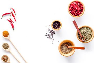 Colorful dry herbs and spices for cooking food white kitchen table background top view space for text