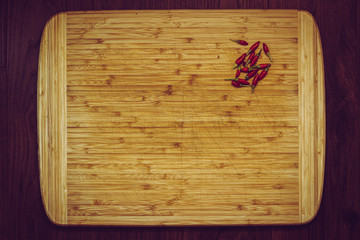 wooden kitchen cutting board with peppers