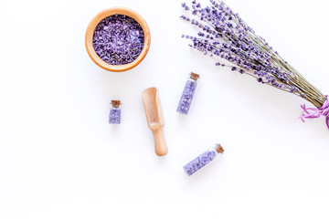 home spa with lavender herbs cosmetic salt for bath on white desk background top view mock-up