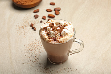Cup of tasty cocoa drink with marshmallow on light background