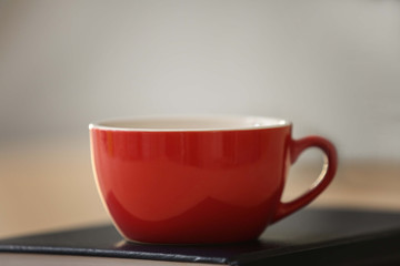 Red cup on book, closeup