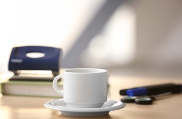 Obraz na płótnie Canvas White cup on office table