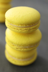 Tasty homemade lemon macarons on table