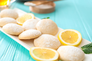 Plate with homemade lemon cookies on wooden table