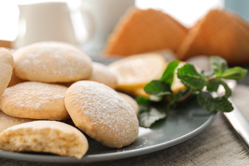 Plate with homemade lemon cookies on table, closeup