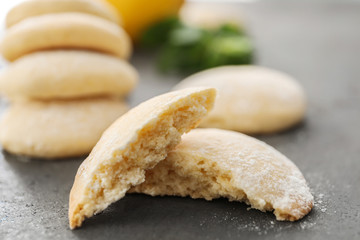 Broken homemade cookie with lemon flavor on table, closeup