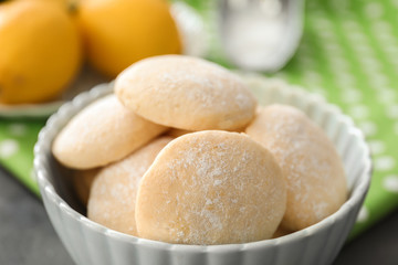 Bowl with homemade lemon cookies on table, closeup