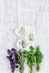 natural oil and fresh greenery for restaurant cooking on wooden kitchen table background top view space for text