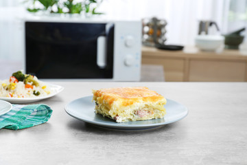 Plate with fat casserole on table