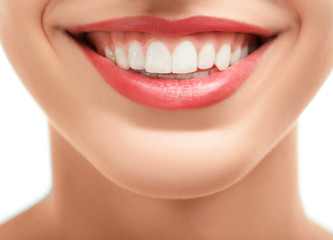 Beautiful young woman with healthy teeth on white background