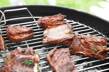 Cooking of appetizing juicy spare ribs outdoors