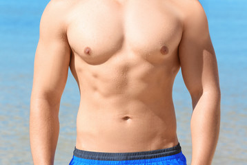 Handsome young man on sea beach