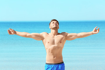 Handsome young man on sea beach