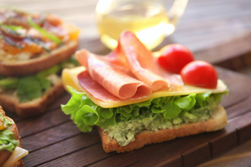Tasty sandwich on wooden board, closeup