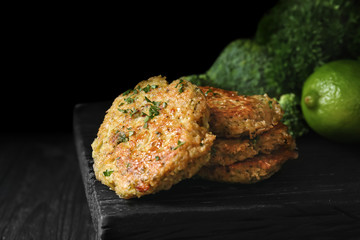 Broccoli pancakes served on black wooden board