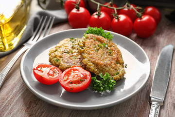 Broccoli pancakes served with cherry tomato and fresh parsley on grey plate