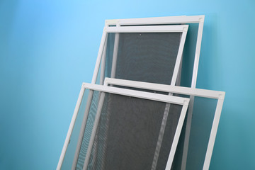 Mosquito window screens on color background