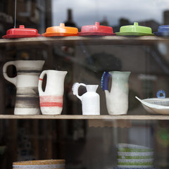 White stylish coffee set in the style of the sixties in the shop window of charity shop
