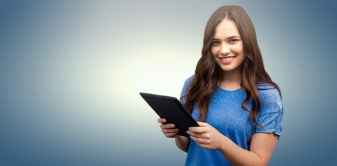 Composite image of brunette women holding tablet 