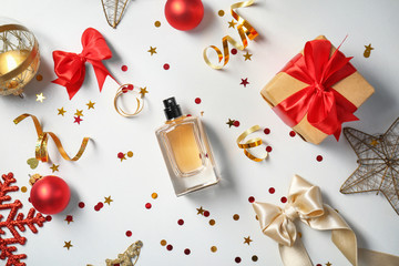 Christmas composition with perfume and gift on white background
