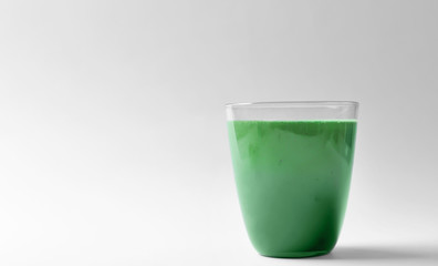 Glass of fresh green smoothie on white background