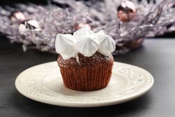 Delicious cupcake with marshmallow on plate