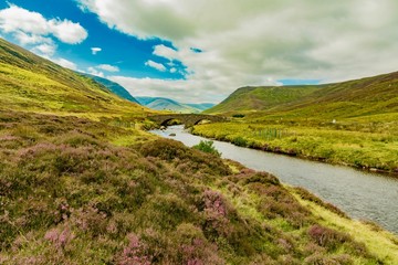 panorama of small medieval stone bridge on the Highland in Scotland