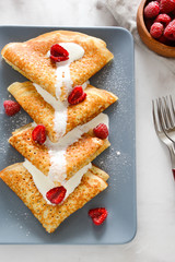 Pancakes with raspberries and cream.