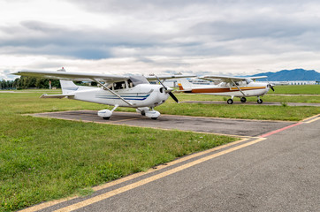 Cessna airplanes parked at a small airport 