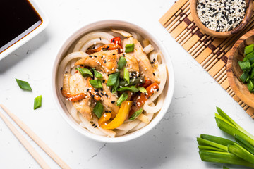 Udon stir-fry noodles with chickenon white.