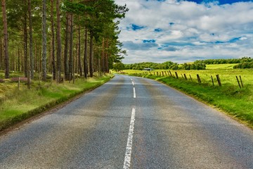 Scotland's roads in the summer among the green hills of the highlands
