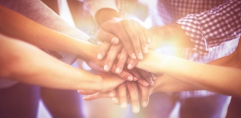 Cropped image of business people stacking hands