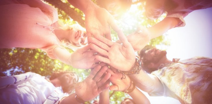 Friends forming a handstack in park