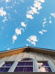 Clouds scattered across a blue sky with 3 windows
