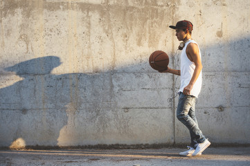 Obraz na płótnie Canvas Young Man Holding a Basketball Ball