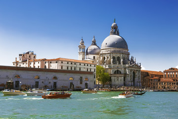 Fototapeta na wymiar Venice, the Grand canal, the Cathedral of Santa Maria Della Salute and boats with tourists. Italy