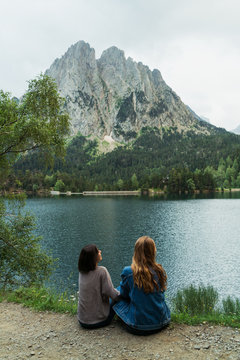 Women sitting at lake