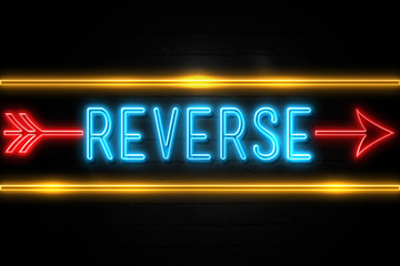 Fototapeta premium Reverse - fluorescent Neon Sign on brickwall Front view