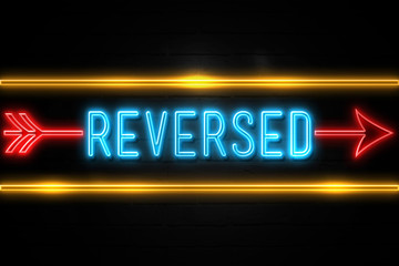 Reversed  - fluorescent Neon Sign on brickwall Front view