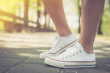 Walking. Woman walking in park, wearing the canvas shoes