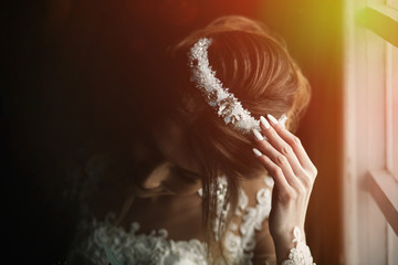 Beautiful tiara with diamonds and veil on head of the bride