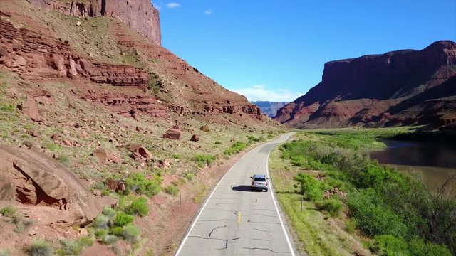 Aerial Shot of suv truck trough scenic road  by River 4K