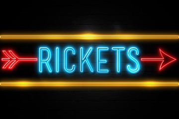 Rickets  - fluorescent Neon Sign on brickwall Front view