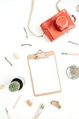 Clipboard with blank paper, retro camera, succulent, tools for handmade arts on white background. Top view, flat lay hipster artist concept.