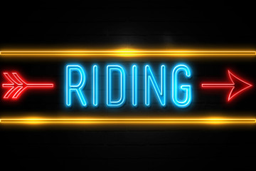 Riding  - fluorescent Neon Sign on brickwall Front view