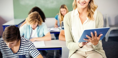 Fototapeta premium Female teacher using digital tablet in class