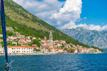 MONTENEGRO - JUNE 04/2017. Tourists sailed on the yacht past the city of Perast in the Boka Bay of...